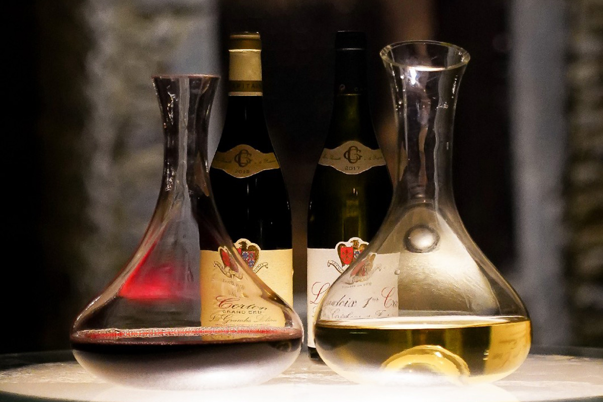 Red and White Burgundy in wine decanters in the tasting cellar